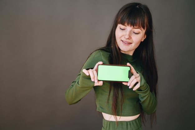 A woman holding a smartphone with a discount code displayed on the screen. She is smiling and surrounded by shopping bags, indicating a successful and thrifty shopping experience. The background is a brightly lit modern shopping mall.