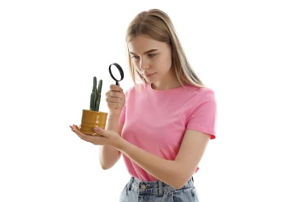 A person holding a magnifying glass over a product label, focusing on vague and unsubstantiated terms like 