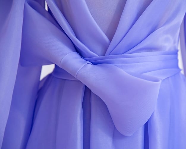 A close-up of a vibrant electric lavender silk scarf draped on a mannequin, with soft lighting highlighting its rich hue.