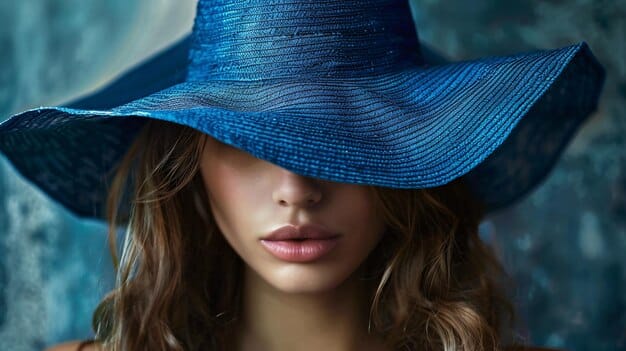 A stylish model wearing a flowing electric blue dress, elegantly paired with accessories in a warm terracotta or sun-baked clay shade, showing a sophisticated contrast.