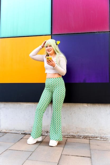 A model wearing wide-leg trousers with a vibrant retro psychedelic print, paired with a simple fitted top, exuding a stylish 70s vibe.