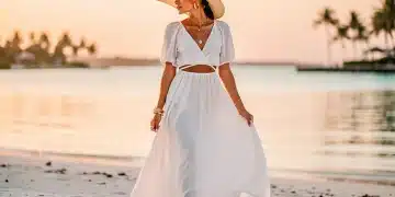 Elegant woman in white maxi dress on beach, showcasing 2026 resort wear trends
